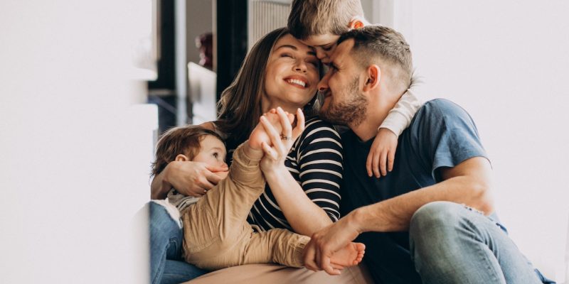 Young family with their sons at home having fun